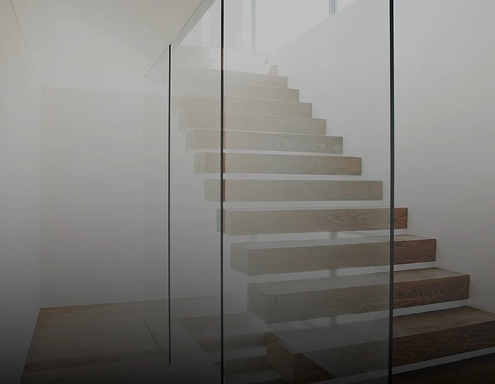 A stair case with glass border
