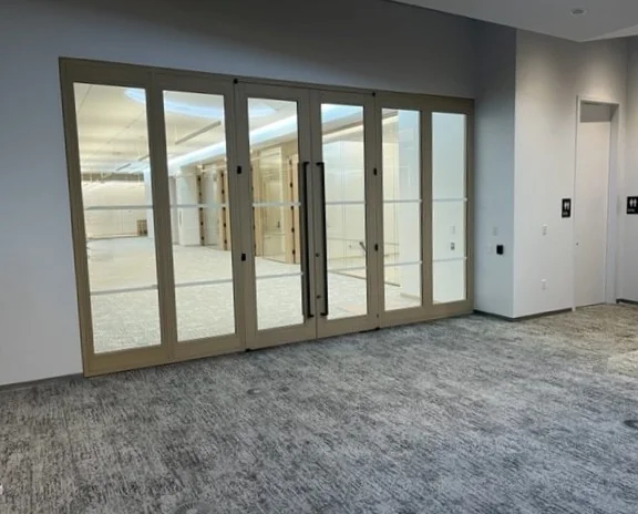 A bullet resistant glass door built on a white frame